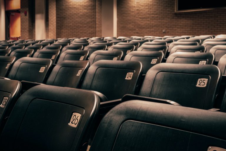 Numbered seats in an empty theatre (theater).